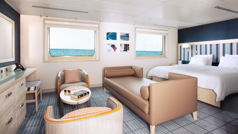 A beautiful Suite with a large bed, chaise style couch and seating aboard the Santa Cruz II cruising the Galapagos Isles