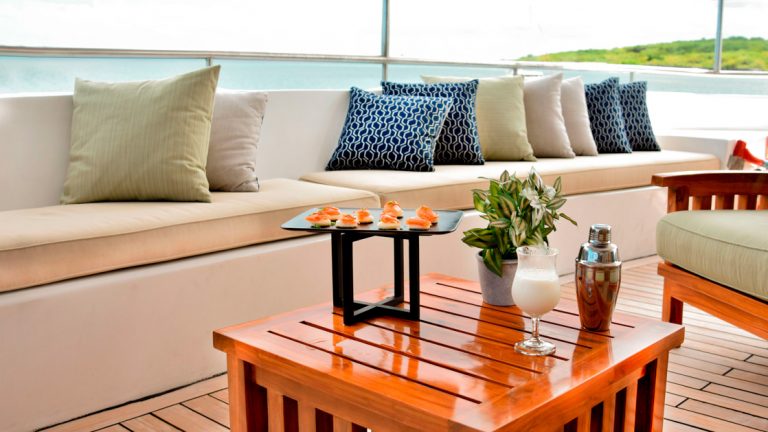 The aft lounge aboard the Seaman Journey with many comfortable cushions and pillows to use while cruising through the Galapagos