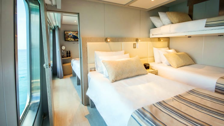 triple cabin with 3 beds and an adjoining room aboard the theory yacht