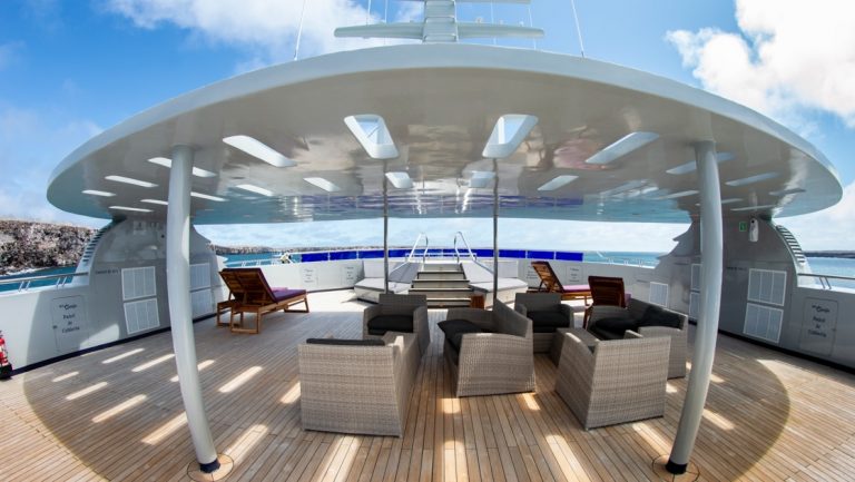 Sundeck on Galapagos Horizon trimaran with teak deck, padded rattan loungers, shade & sun.