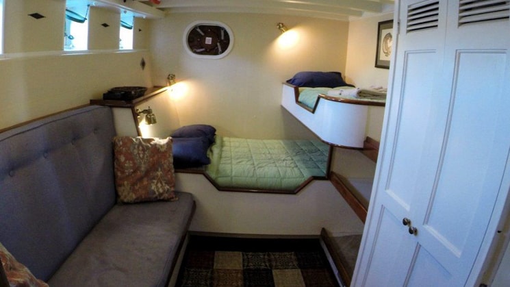 Cabin 1 with a hanging locker and built-in seating aboard the Westward