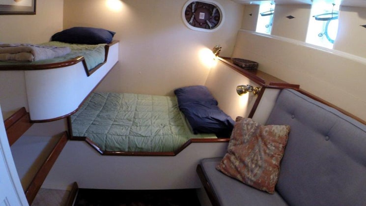 westward cabin 2 with one large bed and twin bunk and small couch seat