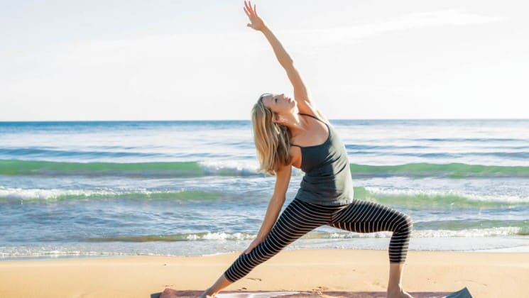 woman doing yoga on beach in channel islands