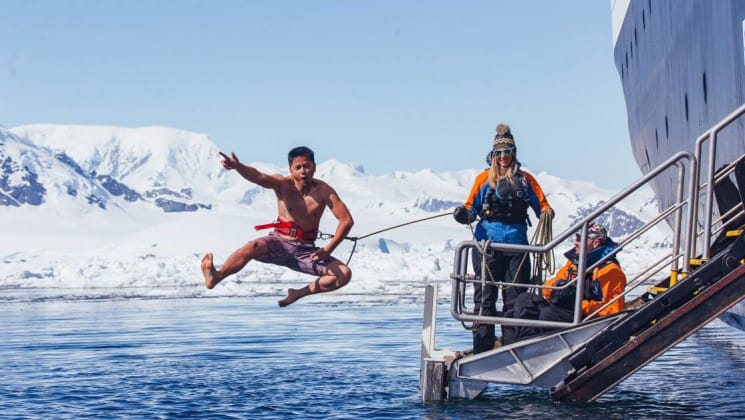A passenger on crossing the antarctic circle jumps overboard to take the polar plunge