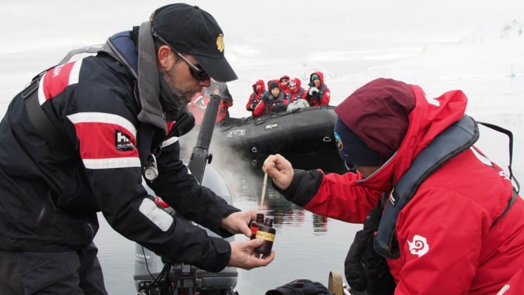 Passengers on the expedition study plankton in antarctica