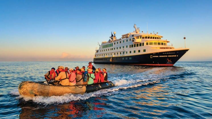 A zodiac boat takes passengers from the National Geographic Endeavour II to the Galapagos Islands for a day of wildlife, flora, and fauna exploration