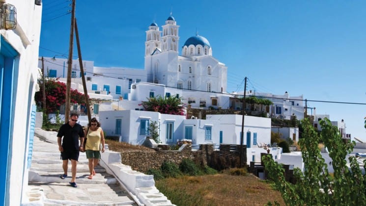 a couple from the small ship cruise take a walking tour along the greek isles