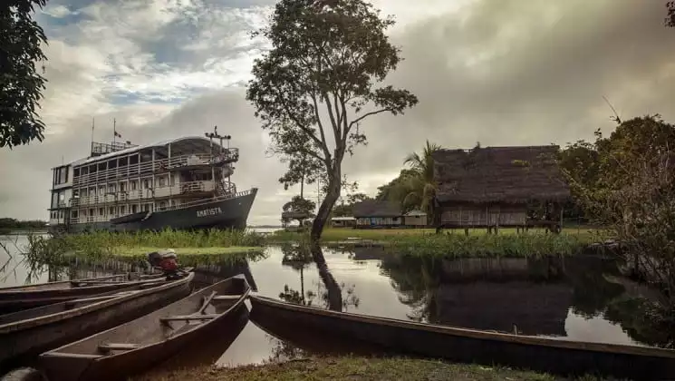 Small ship amatista docks in a remote village in the Peruvian Amazon