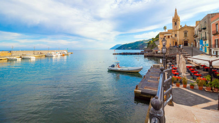 small boat near a dock along the promenade of on Lipari Island of Sicily in Italy