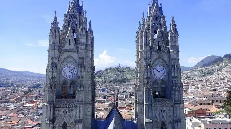 twin clock towers on a sunny day overlooking the city on the quito and guayaquil galapagos land tour