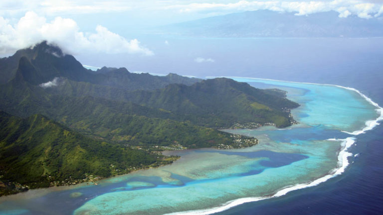 Aerial of Moorea and Tahiti in the South Pacific islands, French Polynesia with clouds above
