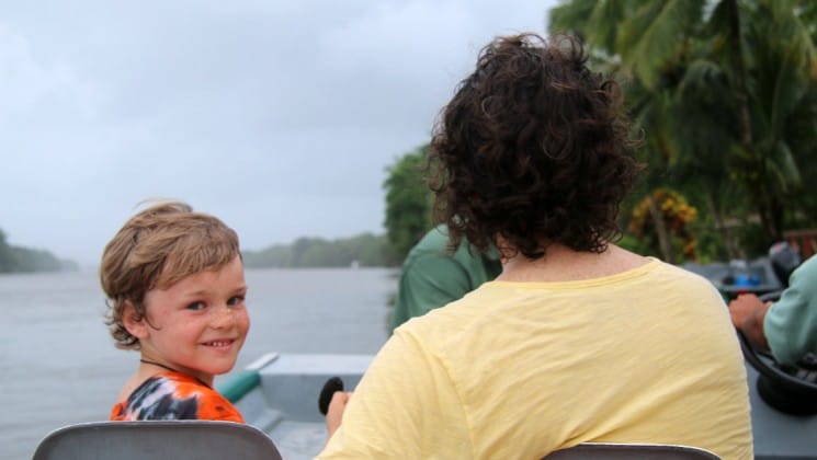 father and son on boat on costa rica family adventure land tour
