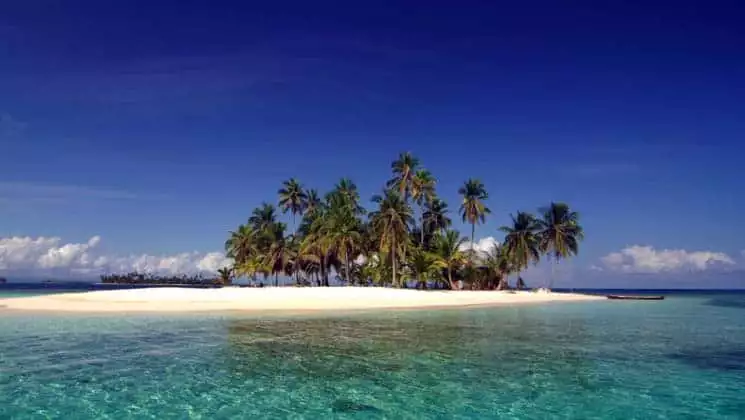A remote white-sand island with palm trees in Panama