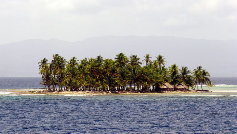 A remote island with trees and small huts in Pananma