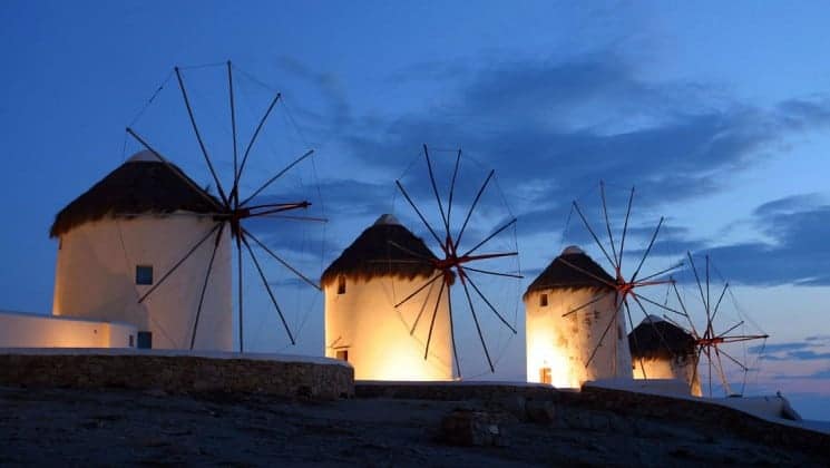 The windmills of mykonos, in greece, illuminated at night