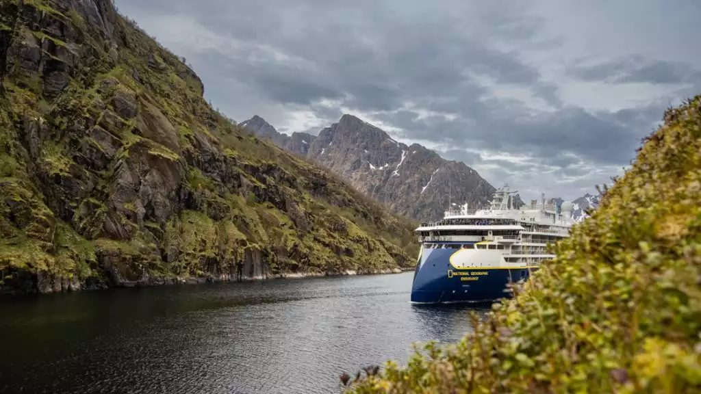 Nat Geo Endurance or Resolution crusing through a mountains waterway during a small ship cruise through Norway.