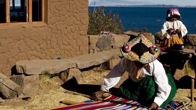 peruvian woman weaving on puno & lake titicaca land tour