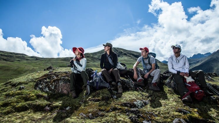 four trekkers in the mountains of peru sit and rest on sacred valley & lares adventure to machu picchu