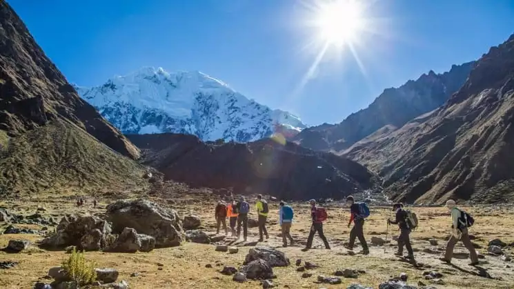 group of hikers in mountains on sunny day on salkantay trek to macchu picchu
