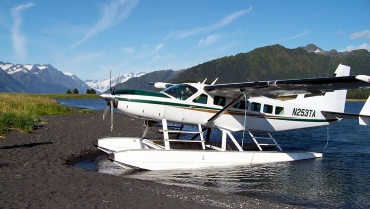 float plane landed at shore on ultimate alaska adventure land tour