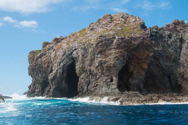 A cave on the ocean with waves receding.