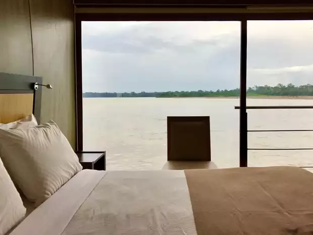View of the Ecuadorian Amazon river from the bedroom aboard the Anakonda. 