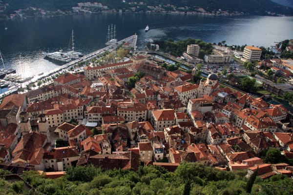 View of Kotor from a fortress hike with small ship in the bay. 