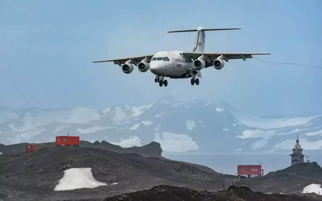 an airplane lands on a strip in antarctica