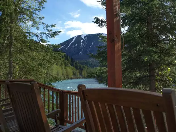 A scenic view from the deck of a Alaskan Wilderness lodge overlooking the Kenai River and forest.