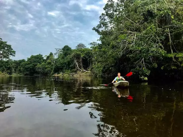A man kayaking on the Ecuadorian Amazon jungle. 