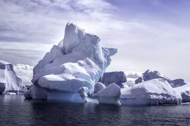 Unique shaped icebergs and different shades of blue as seen from a small ship cruise in Antarctica.