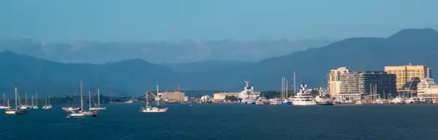 The Cairns waterfront with ships and sailboats.
