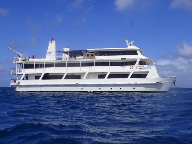 An image of the Coral Expedition II in Australia with three decks and white hull.