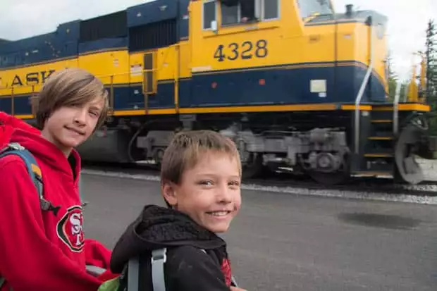Two boys waiting to board the Alaska Railroad train. 