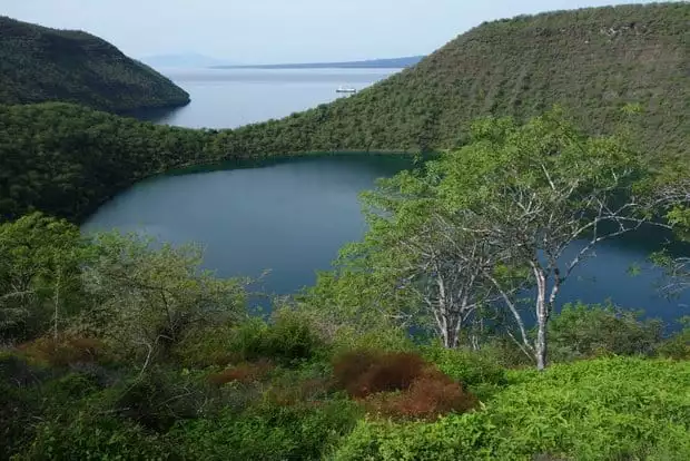 A lake hidden behind a narrow peninsula on a Galapagos island.