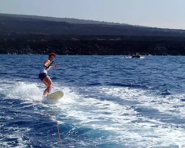 Hawaiian cruise skurfing behind the skiff