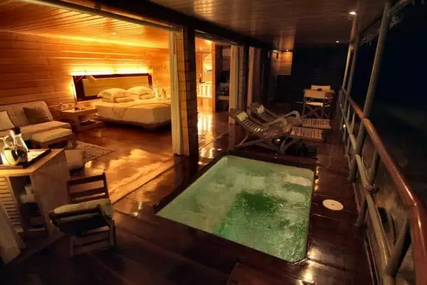 A teal colored plunge pool on the deck of the  all wood Deluxe Suite aboard Delfin I 