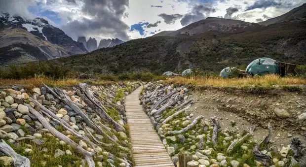 View of the boardwalk to a group of dome EcoBase camps on the valley floor in Patagonia's Torres del Paine National Park.