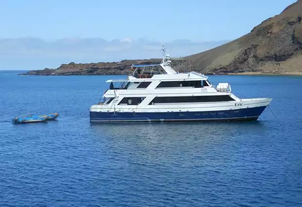 Small ship cruise Letty anchored with 2 zodiacs floating behind the stern in the Galapagos.