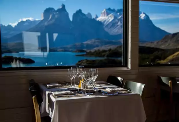 Panoramic view of Lake Pehoe and mountains from the dining room at Explora Lodge.