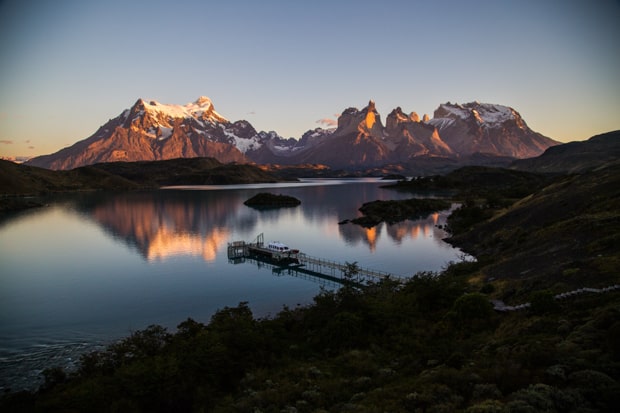 Bird's eye view of a sunset of Lake Pehoe and the mountain range reflecting in the lake at Torres del Paine National Park.