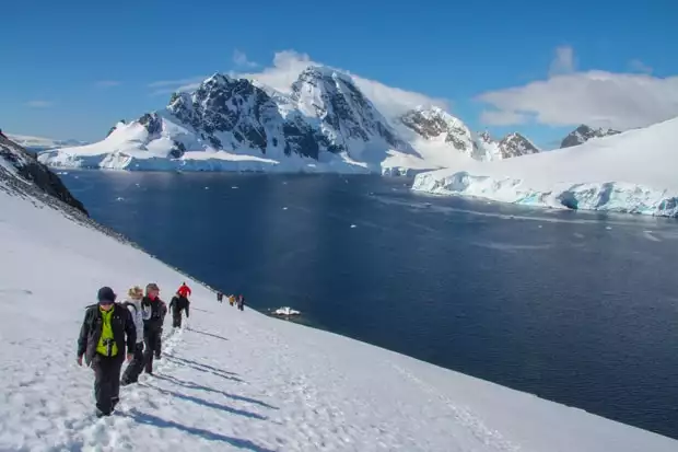 Guests hiking in Antarctica on the snow. 