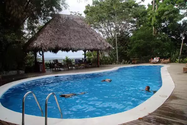 Young travelers playing in a pool at a Costa Rican Lodge.