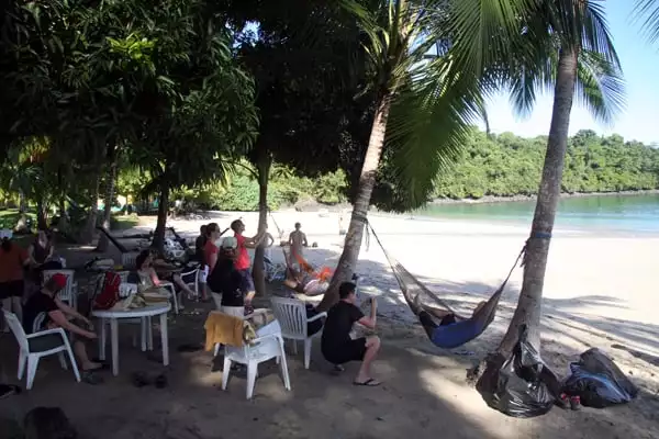 Guests from a small ship Costa Rica and Panama cruise relaxing at a beach on Coiba Island. 