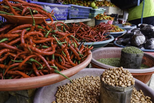 Various local spices set out in bowls at a market in Indonesia. 