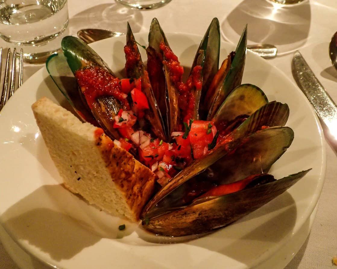 Fresh local dinner of green mussels on board a small cruise ship in the south pacific islands. 