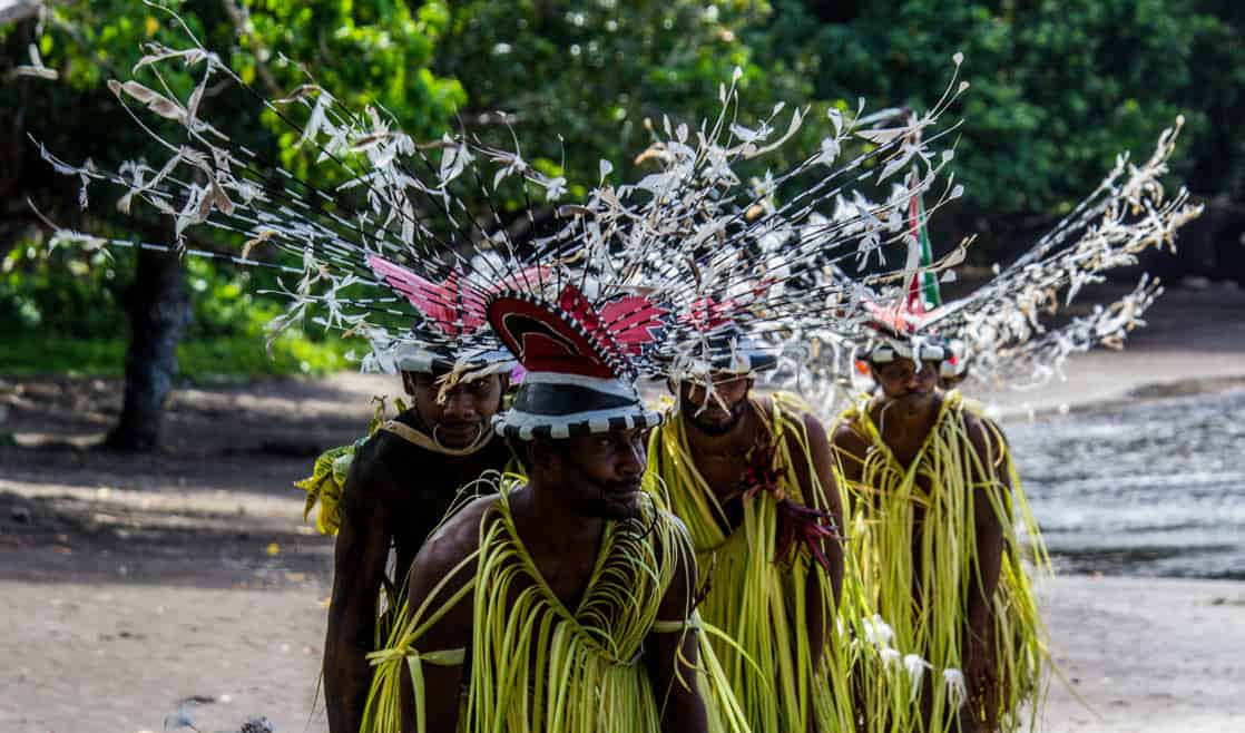 Local men wearing lionfish headress costumes in Ureparapara South Pacific.