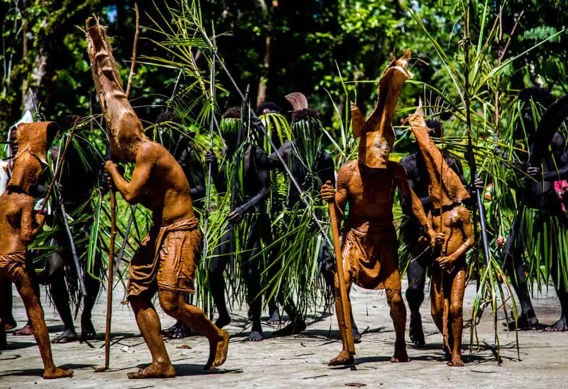 Locals performing a mud dance seen from a small ship cruise in the south pacific islands. 
