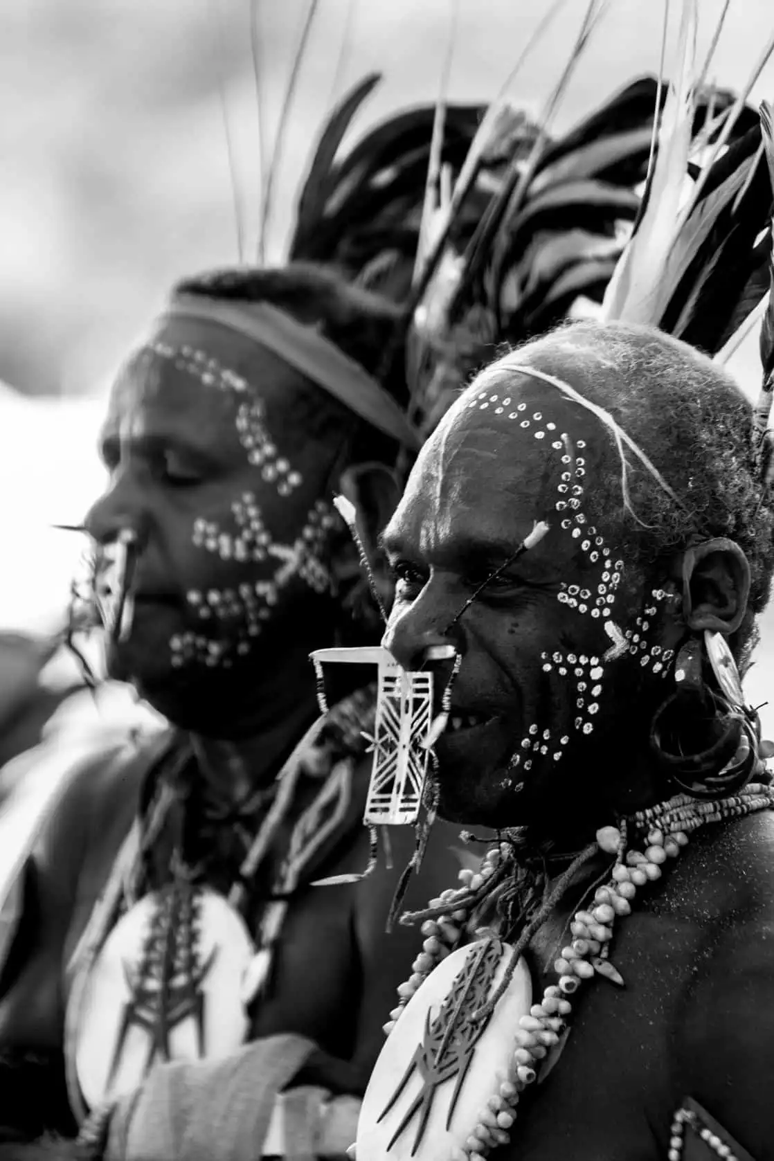 Tribal mean wearing face paint and piercings on an island in the south pacific. 