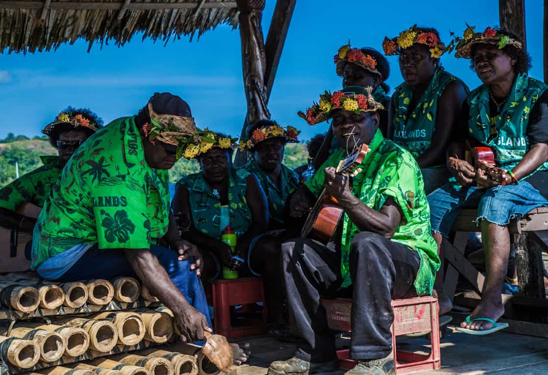 Local village band playing instruments by the beach in the south pacific. 